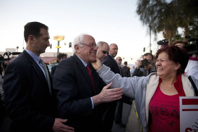Democratic presidential candidate Sen. Bernie Sanders, I-Vt., center, is greeted by a culinary worker protesting outside Sunrise Hospital on Thursday, Feb. 18, 2016, in Las Vegas. 