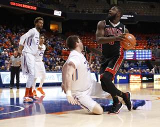 UNLV's Jordan Cornish (3) gets collides with Boise State's Nick Duncan, and is called for charging during the first half of an NCAA college basketball game in Boise, Idaho, on Tuesday, Feb. 23, 2016. (AP Photo/Otto Kitsinger)