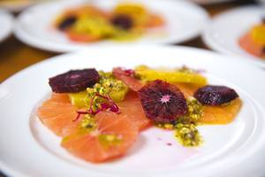 A citrus salad dish with pistachio oil is shown during a gourmet 6-course dinner at Artisanal Foods Tuesday, March 1, 2016.