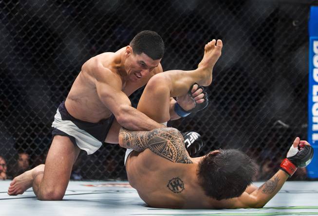 Welterweight Nordine Taleb pounces on Erick Silva after taking him to the canvas in their fight during UFC 196 from the MGM Grand Garden Arena.