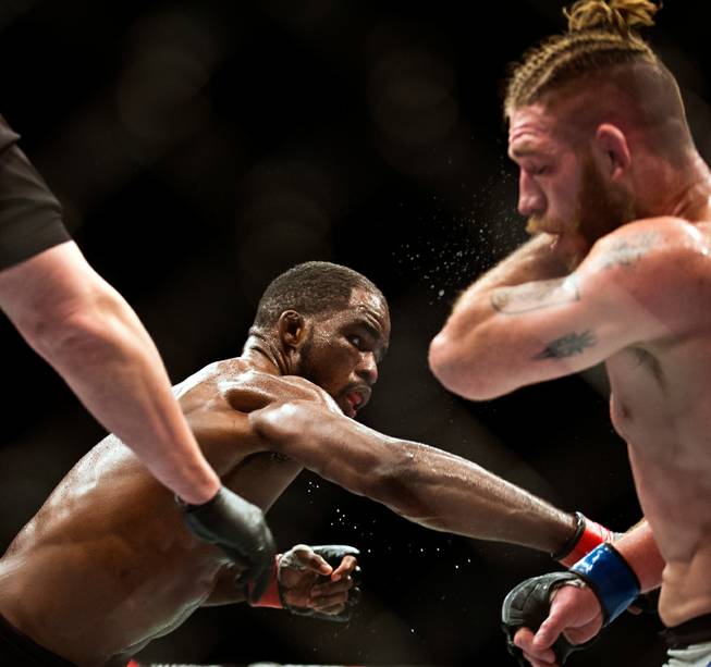 Light Heavyweight Corey Anderson connects once more with a punch to the head of Tom Lawlor in their fight during UFC 196 from the MGM Grand Garden Arena on Saturday, March 5, 2016.