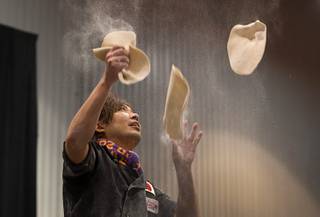 Yuya Mizuno of Japan juggles pizza dough during the World Pizza Games Freestyle Acrobatic Dough Tossing competition at the 2016 International Pizza Expo in the Las Vegas Convention Center Tuesday, March 8, 2016.