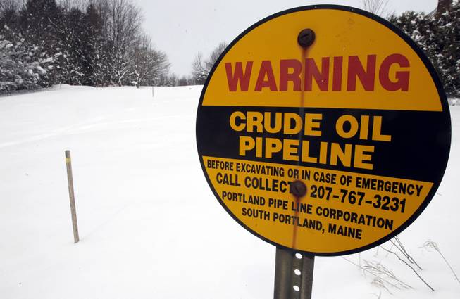 In this March 20, 2013 file photo, a sign marks the location of an oil pipeline in Irasburg, Vt. The pipeline buried under three New England states that carried foreign crude oil from the Port of Portland to refineries in Montreal for 75 years has been mothballed. The oil has stopped flowing. 