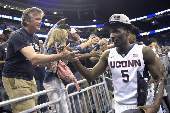 Connecticut guard Daniel Hamilton (5) slaps hands with fans after an NCAA college basketball game against Memphis in the finals of the American Athletic Conference men's tournament in Orlando, Fla., Sunday, March 13, 2016. Connecticut won 72-58 and Hamilton was named the tournament MVP.