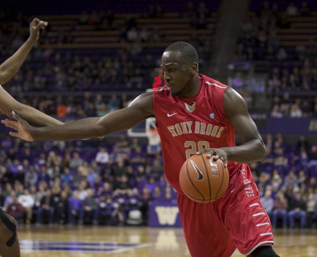 Stony Brook Jameel Warney dribbles the ball during the first half of an NCAA college basketball game against Washington Sunday, Dec. 28, 2014, in Seattle. Stony Brook won 62-57.