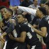 Providence forward Rodney Bullock, second from left is embraced by teammates after hitting the game-winning basket against Southern California during the second half of a first-round men's college basketball game in the NCAA Tournament, Friday, March 18, 2016, in Raleigh, N.C. Providence won 70-69. 