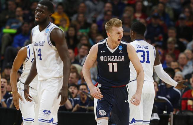 Gonzaga forward Domantas Sabonis celebrates after scoring a basket as Seton Hall guard Ismael Sanogo and forward Angel Delgado turn away during the second half of a first-round men's college basketball game Thursday, March 17, 2016, in the NCAA Tournament in Denver. Gonzaga won 68-52.