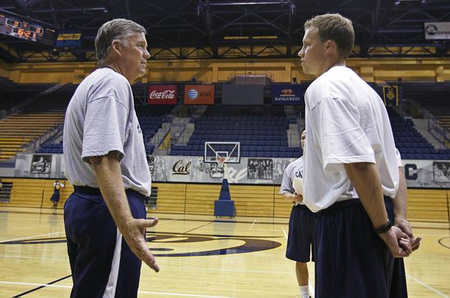 In this Sept. 25, 2008, file photo, then-California head coach Mike Montgomery, left, talks with his son, John Montgomery, right, during basketball practice in Berkeley, Calif. When California's season ended, John Montgomery reached out to a handful of his former players and wished them a deep, special NCAA Tournament run. That was before the draw came out. Montgomery is now an assistant coach at Hawaii, and will face the Golden Bears in a first-round matchup on Friday. 