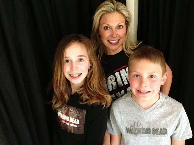 This March 29, 2016, photo released by Ericka Calcagno, center, shows her with her daughter Gina Binder, 12, and son Jean-Luc Binder, 9, wearing T-shirts from "The Walking Dead" at their home in Farmington Hills, Mich.
