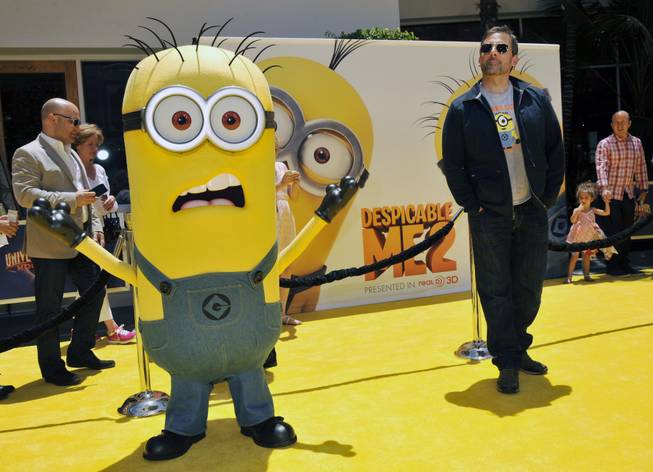 In this June 22, 2013, photo, Steve Carell, a cast member in "Despicable Me 2," competes for attention on the carpet with a minion character from the film in Universal City, Calif.