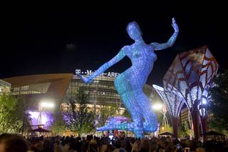The Bliss Dance sculpture by artist Marco Cochrane is officially illuminated Monday, April 4, 2016, at The Park. The new pocket park, lined with restaurants and seating for outdoor dining, runs from the Las Vegas Strip to the new T-Mobile Arena.