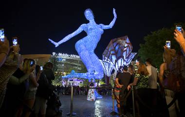 The Bliss Dance sculpture is officially illuminated Monday, April 4, 2016, at The Park. Deja Solis, the model for the sculpture, is at center. The new pocket park, lined with restaurants and seating for outdoor dining, runs from the Las Vegas Strip to the new T-Mobile Arena.
