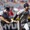 Washington Nationals' Bryce Harper, right, is greeted by third base coach Bob Henley, left, after hitting a solo-home run in the first inning of a baseball game against the Atlanta Braves, Monday, April 4, 2016, in Atlanta. 