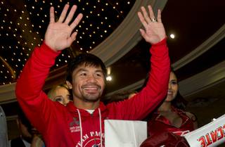 Welterweight boxer Manny Pacquiao of the Philippines waves to fans after arriving at the MGM Grand Tuesday, April 5, 2016. Pacquiao and Timothy Bradley Jr. will meet for their third fight at the MGM Grand Garden Arena on Saturday, April 9.