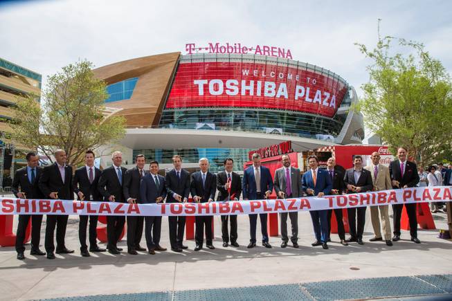 At center with red scissors: VP at Toshiba Fumio Otani, MGM CEO Jim Murren, to right of Otani, and other arena officials participate in the ribbon cutting ceremony during the T-Mobile Arena's opening day celebration, Wed. April 6, 2016.