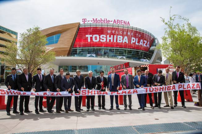 At center with red scissors: VP at Toshiba Fumio Otani, MGM CEO Jim Murren, to right of Otani, and many other arena officials participate in the ribbon cutting ceremony during the T-Mobile Arena's opening day celebration, Wed. April 6; 2016.