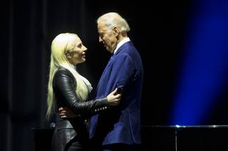 Lady Gaga speaks with Vice President Joe Biden after a performance of her song 