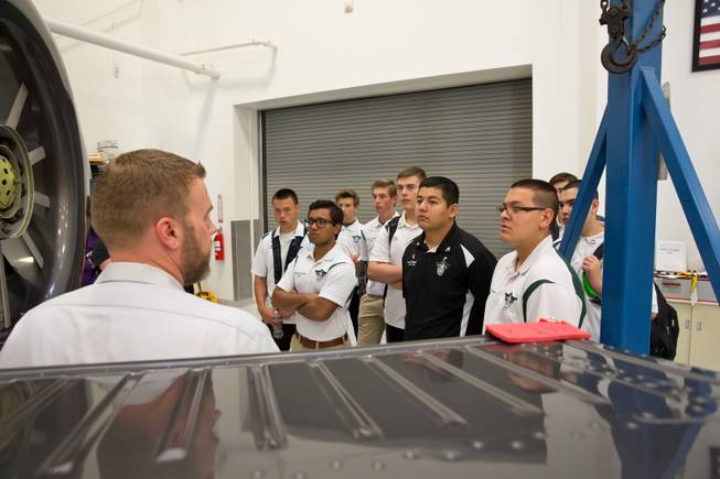 Tim Hoffman, Quality Assurance Manager for Maverick Aviation, speaks to students from Rancho High School's aeronautics program during a tour of Maverick's Henderson Executive Airport facility, Friday April 8, 2016.