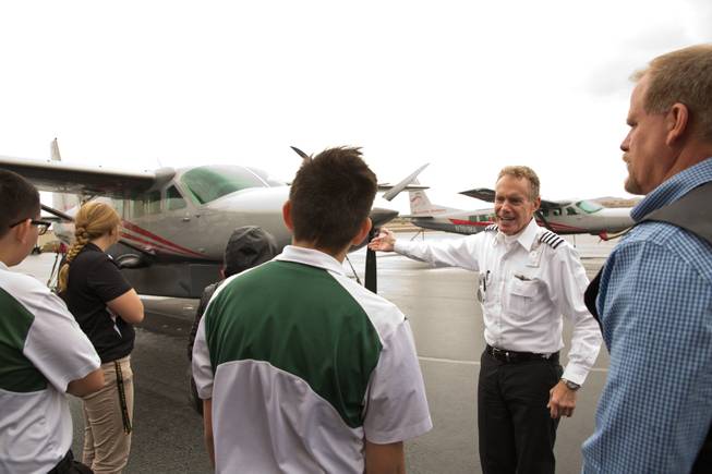 C.R. Sherman, Chief Pilot for Maverick Airlines, speaks to students from Rancho High School's aeronautics program during a tour of Maverick's Henderson Executive Airport facility, Friday April 8, 2016.