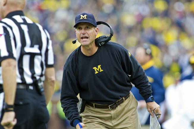 Michigan head coach Jim Harbaugh tries to get the attention of a line judge Sept. 12, 2015.