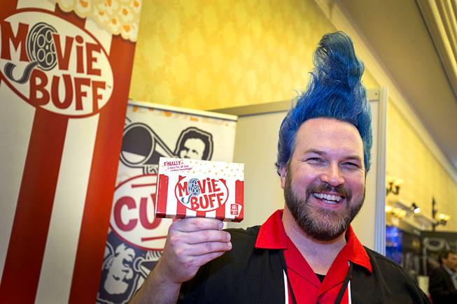 Justin Purvis poses with his Movie Buff game during the CinemaCon trade show at Caesars Palace Wednesday, April 13, 2016. Purvis said he developed the game as a place for (what his mother called) his "useless knowledge."