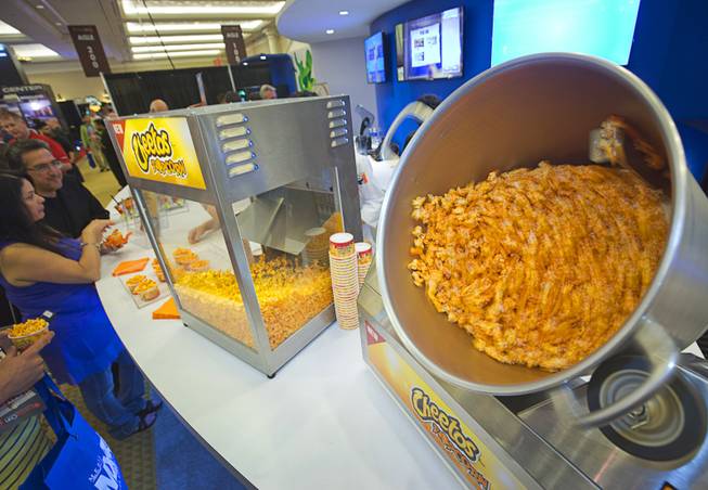 A rotating kettle mixes popcorn and Cheetos during the CinemaCon trade show at Caesars Palace Wednesday, April 13, 2016. CinemaCon is a convention for movie theater owners.