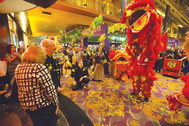 Bill Boyd, executive chairman of Boyd Gaming Corp., and Marianne Johnson, the company’s executive vice president and chief diversity officer, take part in a lion dance ceremony at the Orleans on March 2. Being hit by a piece of lettuce thrown by a performer is considered good luck.