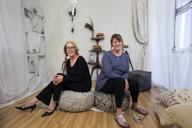 Artists Diane Butner, left, and Kathleen Nathan pose in the “Reading Room” at Nest Studio, 1800 S. Industrial Rd., Sunday, April 17, 2016.