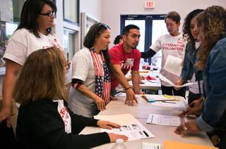 Organizers troubleshoot problems during a citizenship drive workshop at the Painters Union on Saturday, April 16, 2016. Organizers have set a goal of helping 2,500 legal resident immigrants apply for citizenship this year. 