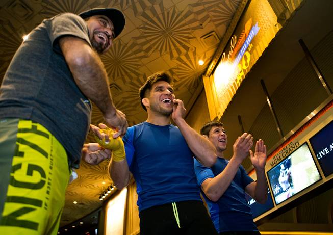 Flyweight Henry Cejudo shares a laugh while being taped up during a UFC 197 open workout with his team at the MGM Grand on Wednesday, April 20, 2016.