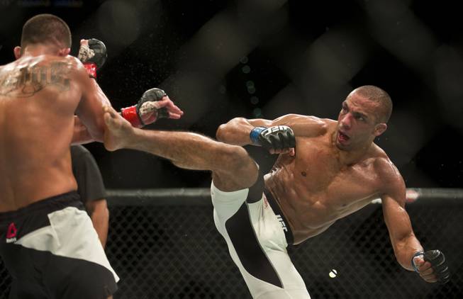 Lightweight Anthony Pettis recoils from another kick by Edson Barboza during their UFC 197 match at the MGM Grand Garden Arena on Friday, April 23, 2016.