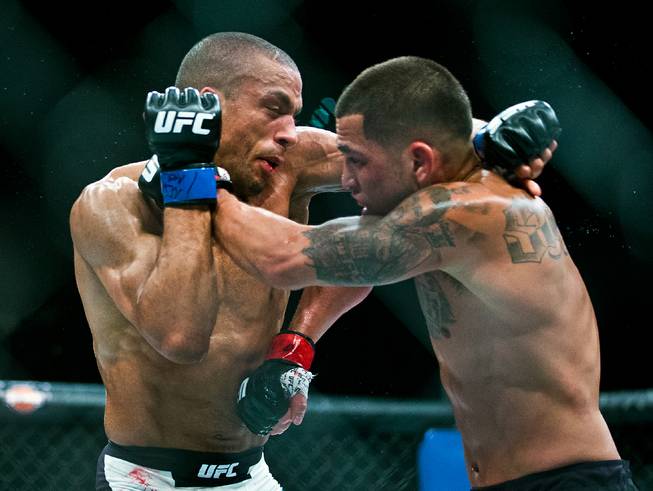 Lightweight Edson Barboza and Anthony Pettis tangle in close during their UFC 197 match at the MGM Grand Garden Arena on Friday, April 23, 2016.