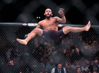 Flyweight Champion Demetrious Johnson celebrates his knockout of Henry Cejudo during their UFC 197 match at the MGM Grand Garden Arena on Friday, April 23, 2016.