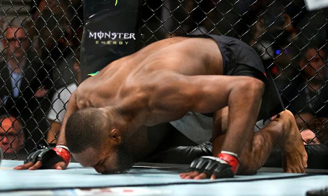 Light Heavyweight Jon Jones kisses the canvas as he readies to face Ovince St. Preux during their UFC 197 match at the MGM Grand Garden Arena on Friday, April 23, 2016.