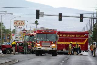 City of Las Vegas Fire units are shown by the intersection of Nellis Boulevard and Washington Avenue after an accident between a pickup truck and a semitrailer Monday, April 25, 2016. The trailer overturned onto it's side in the accident.