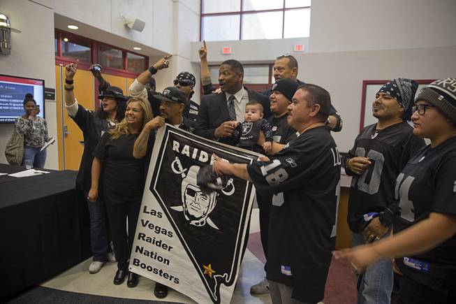 Former Oakland Raiders running back Napoleon McCallum poses with local Raiders fans outside a meeting of the Southern Nevada Tourism Infrastructure Committee at UNLV Thursday, April 28, 2016.