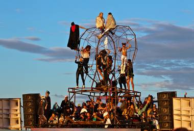 Attendees sit and dance atop a metal heart above the Robot Heart performance area at sunrise during Further Future on Sunday, May 1, 2016.