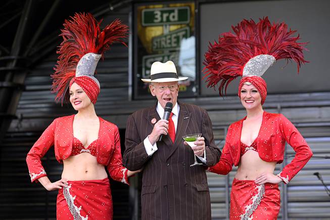 Showgirls Tara Taylor, left, and Jen Vossmer join Showgirls Tara Taylor, left, and Jen Vossmer help LVCVA Host Committee Chairman Oscar B. Goodman greet tourists during a flash mob event Wednesday, May 4, 2016, at the Fremont St. Experience to promote National Travel and Tourism Week.