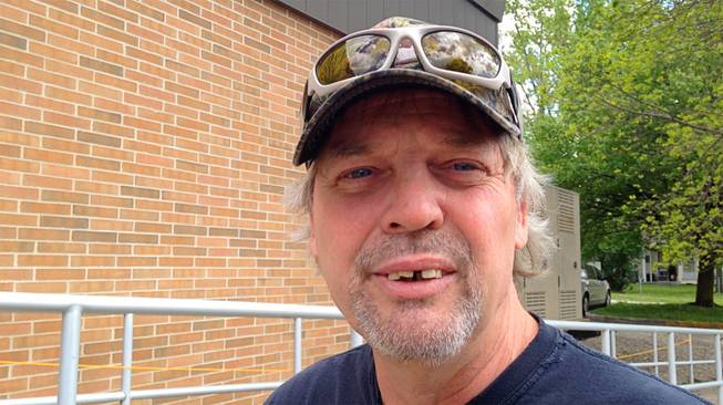 Roger Willett, 51, talks about why he voted for Donald Trump in the Indiana primary on Tuesday, May 3, 2016, outside the polling place at Covington High School in Covington, Ind. Willett said Trump appealed to him because he is not a career politician, and because he has focused on the economy, terrorism and immigration. 