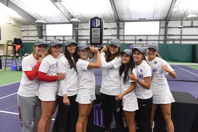 The UNLV women's tennis team hoists their Mountain West Championships trophy after winning the 2016 title on Sunday, May 1. Both Rebels tennis programs and golf programs won Mountain West titles this season, a first in league history.
