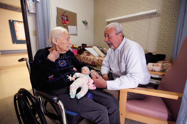 Phyllis Hotchkiss, left, talks to her son, Glen Hotchkiss, on April 14, 2016, at her nursing home in Adrian, Mich. Phyllis, 93, who has dementia and is confined to a wheelchair, was involuntarily discharged from her nursing home earlier in the year, to one further away from her family. Nursing homes are increasingly evicting their most challenging residents, advocates for the aged and disabled say, testing protections for some of society’s most vulnerable.