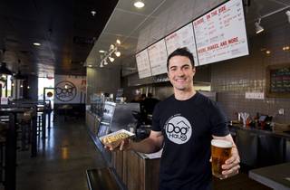 Adam Roll, general manager of Dog Haus poses with a 