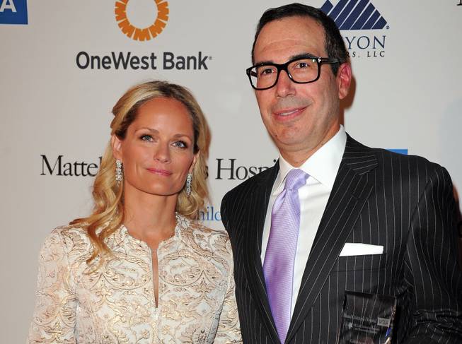 In this April 17, 2013 file photo, Heather Mnuchin, left, and Steven Mnuchin arrive at The Kaleidoscope Ball's "Designing The Future" at the Beverly Hills Hotel in Beverly Hills, Calif. Trump, the presumptive Republican presidential nominee, recently tapped Steven Mnuchin, a New York investor with ties in Hollywood and Las Vegas, to be his campaign fundraiser. 