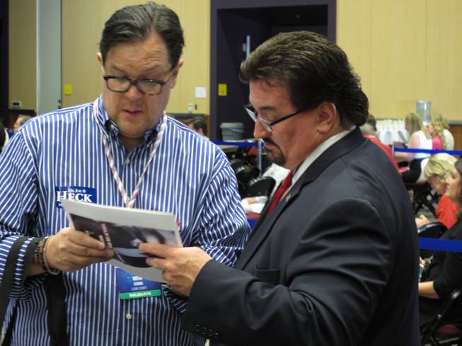 Nevada Republican Party Chairman Michael McDonald, right, talks to Clark County GOP delegate Keith Ozawa on Saturday during the Nevada GOP State Convention at the Reno-Sparks Convention Center in Reno.