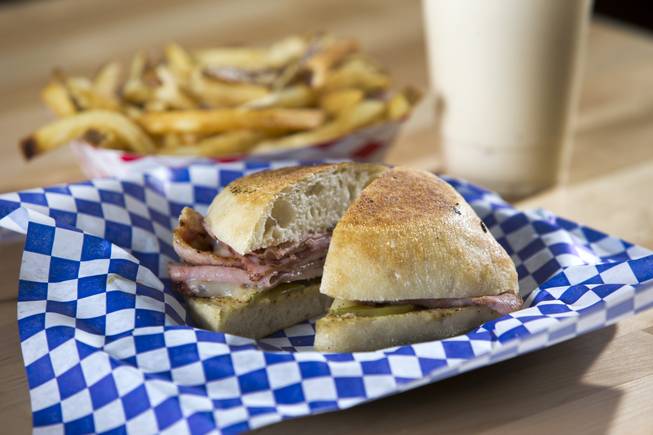 A Cubano sandwich with housemade Canadian bacon is shown with fries and a vanilla malt at Salted Malted Bakery & Creamery, 6584 N. Decatur Blvd., Tuesday, May 17, 2016. The restaurant offers many Canadian specialties such as poutine, peameal bacon, and a variety of sweets.