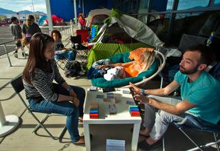 Junie Zhu, Brittany Kostas and Bryan Guercioni play cards and chat while waiting in line at IKEA before it opens, they are amongst the first 42 people who are 1going to receive a free three-seat sofa and the following 100 adults will receive a free armchair on Tuesday, May 17, 2016.