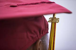 A tassle hangs from an inmate's mortar board during a commencement ceremony at the Florence McClure Women's Correctional Center on Smiley Road Wednesday, May 25, 2016. About 50 female inmates received a high school diploma, a GED, or a vocational certificate. One inmate received a college degree.