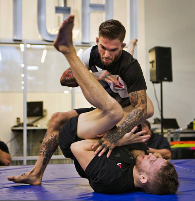 Bantamweight Cody Garbrandt takes down a trainer during the UFC Fight Night workouts at the Las Vegas Harley Davidson store on Thursday, May 27, 2016.