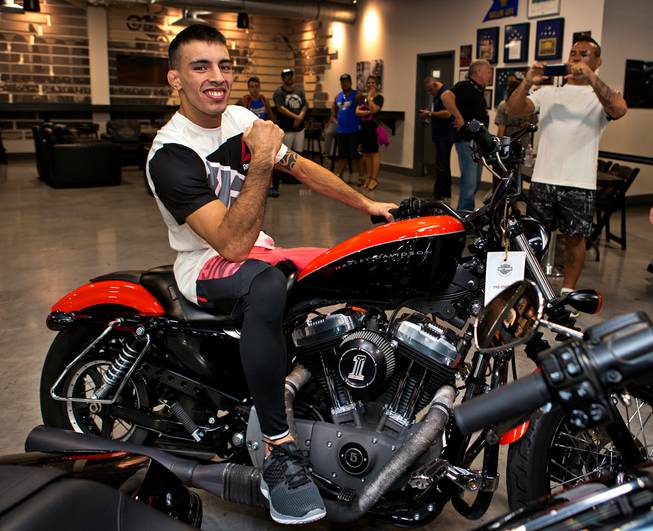 Bantamweight Thomas Almeida poses atop one of the many fine bikes following his UFC Fight Night workout at the Las Vegas Harley Davidson store on Thursday, May 27, 2016.