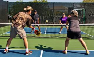 Members with the Sun City Anthem Pickleball Club battle on the courts at Liberty Center on Wednesday, May 25, 2016.